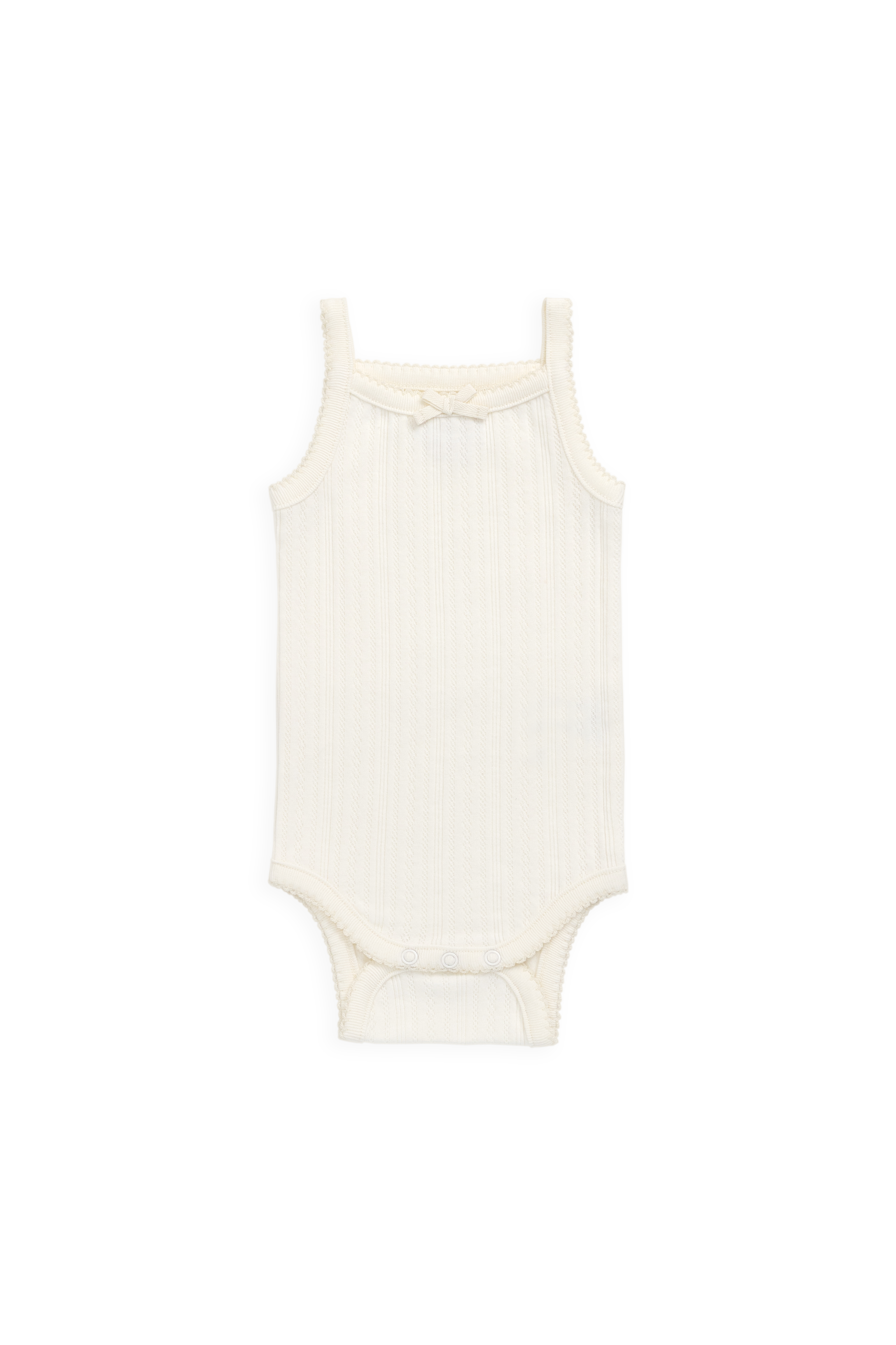 Grenouillère délicate en maille interlock ajourée de coton biologique, coloris parchemin, avec nœud.