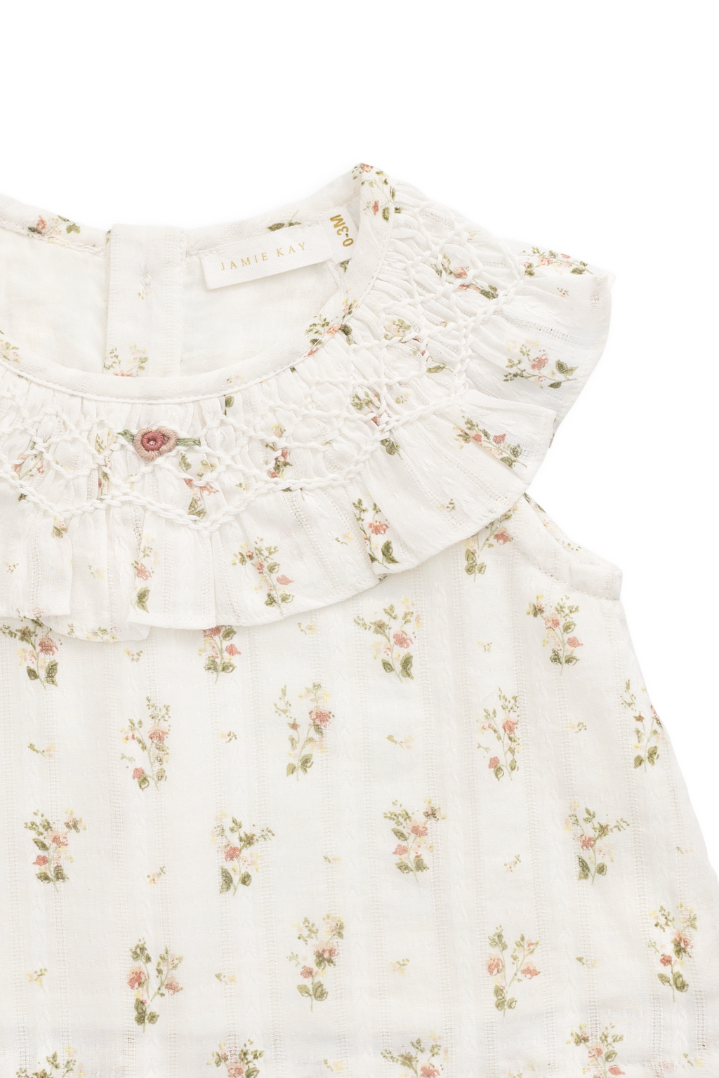 Haut en coton biologique blanc à imprimé floral vintage avec encolure à volants et manches courtes.