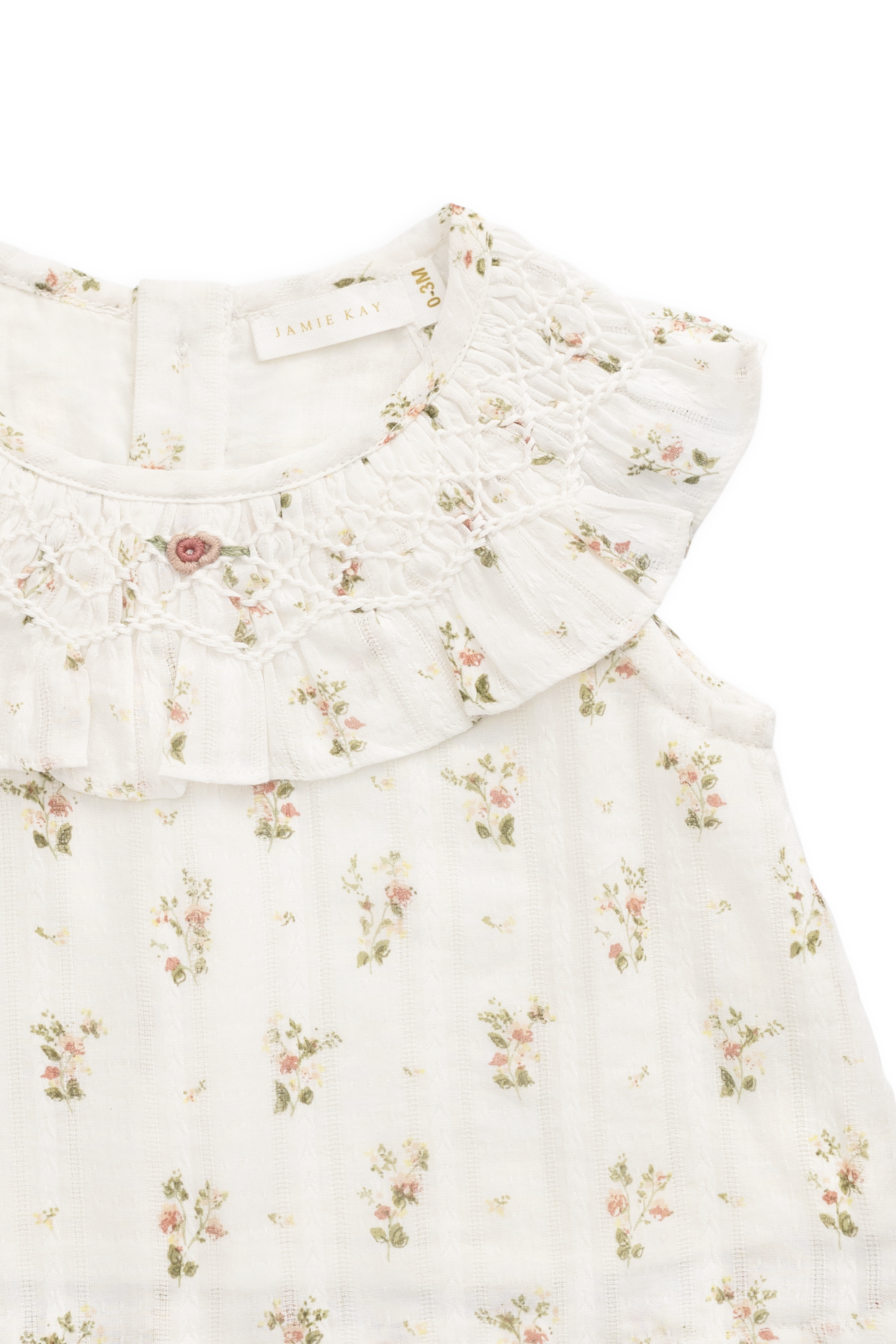 Haut en coton biologique blanc à imprimé floral vintage avec encolure à volants et manches courtes.
